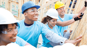 Group of volunteers doing construction work after having signed a volunteer liability waiver.