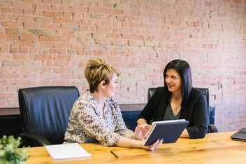 Two pro bono volunteers discussing their nonprofit project.