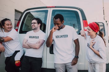 Group of people wearing volunteer t-shirts discussing a volunteer engagement strategy.