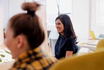 Employee smiling and participating in her company’s volunteer time off program.