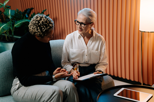 Two women discussing volunteer recruitment challenges and solutions.