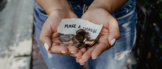 Hands holding change after converting volunteers to donors.