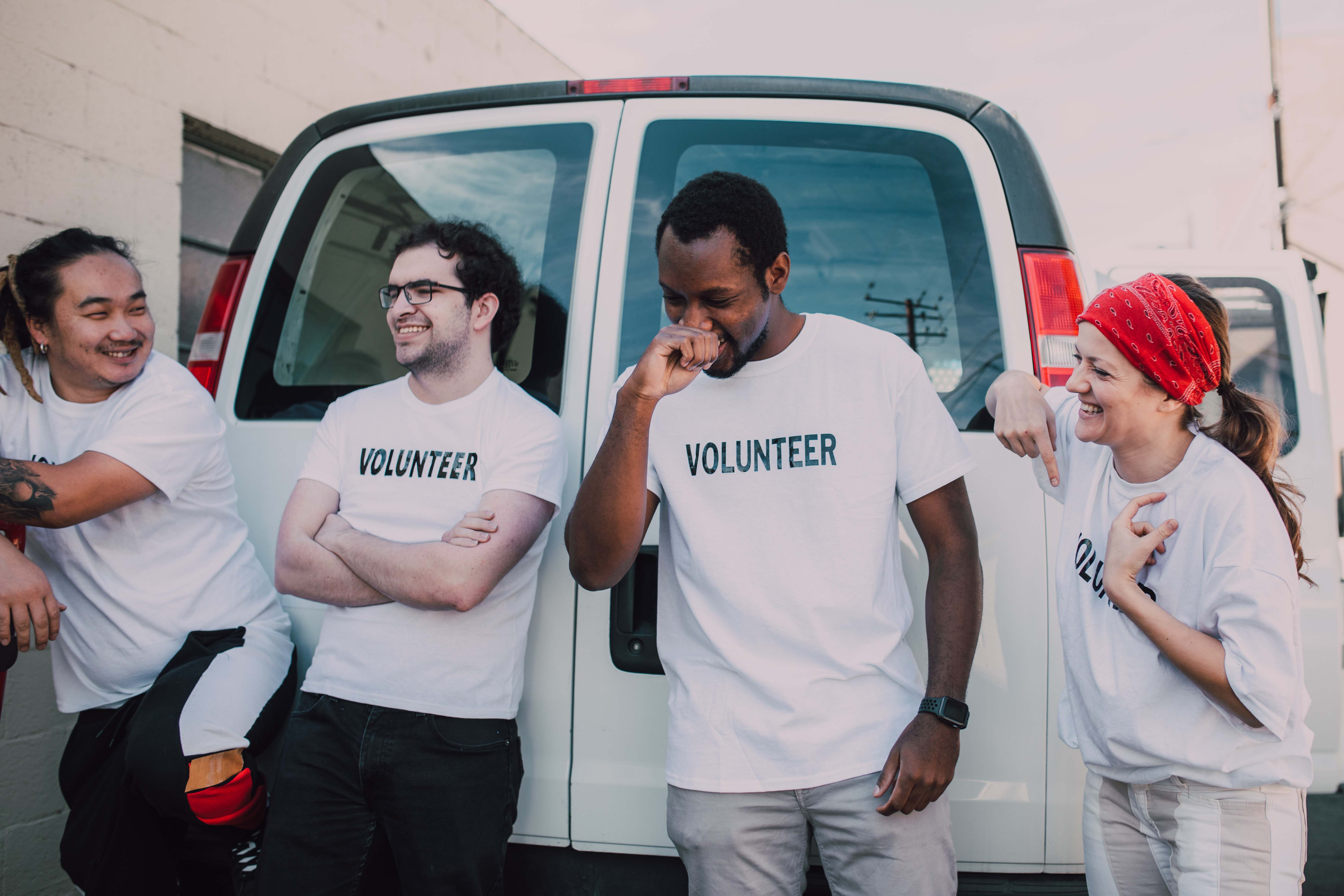 Group of people wearing volunteer t-shirts discussing a volunteer engagement strategy.