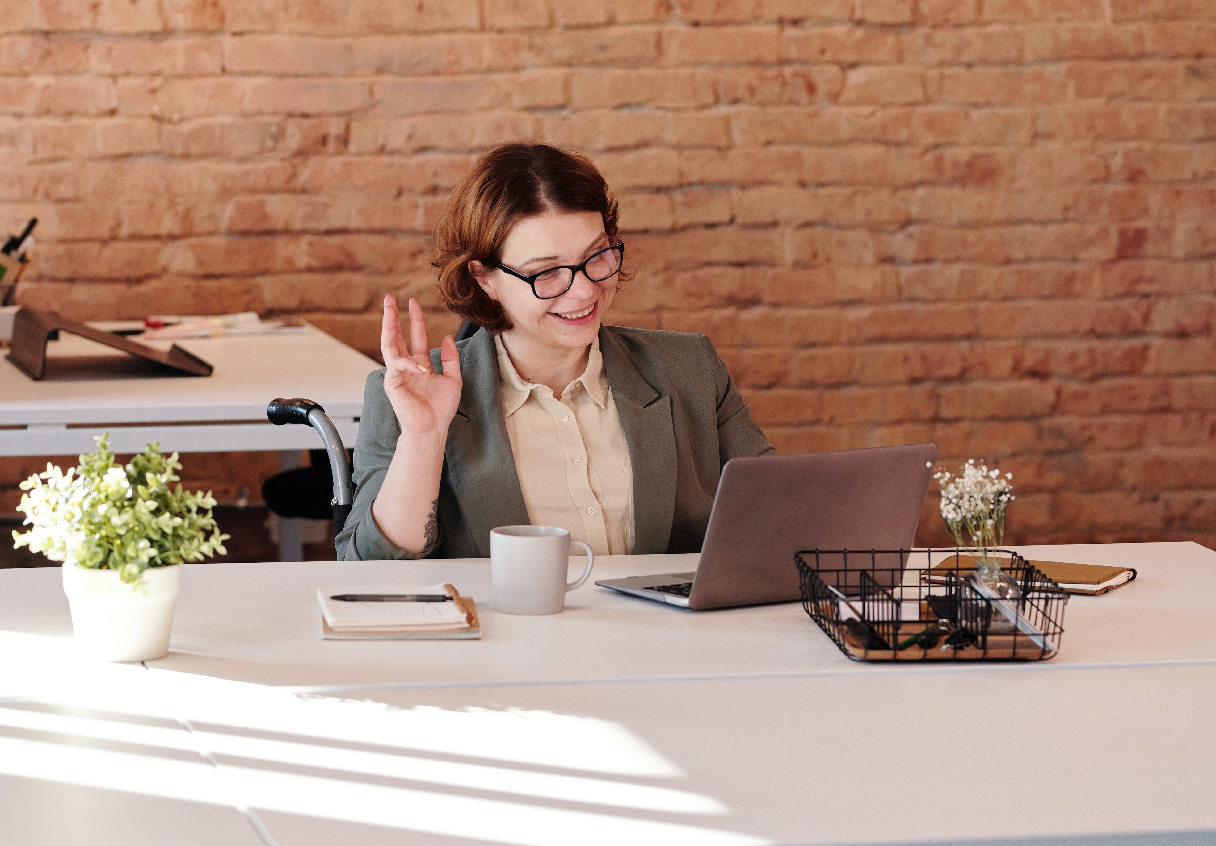 woman working at laptop learning why her volunteer program should invest in technology